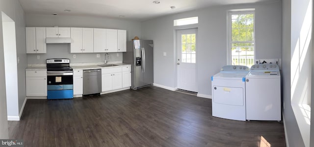 kitchen with sink, white cabinets, stainless steel appliances, washing machine and dryer, and dark wood-type flooring