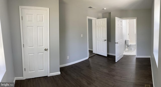 unfurnished bedroom with dark hardwood / wood-style floors