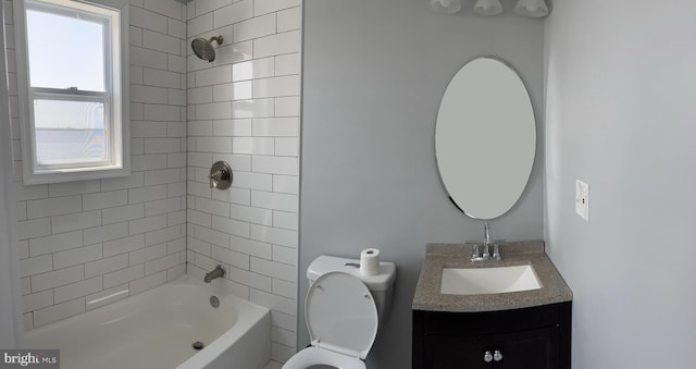 full bathroom featuring vanity, tiled shower / bath combo, and toilet