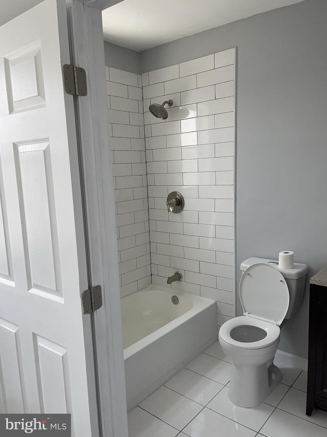 bathroom featuring tile patterned floors, toilet, and tiled shower / bath combo