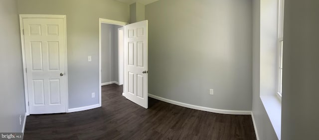 unfurnished bedroom featuring dark hardwood / wood-style flooring