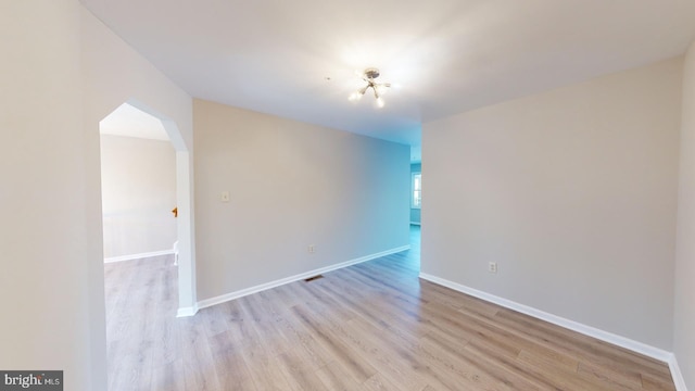 spare room featuring light hardwood / wood-style floors