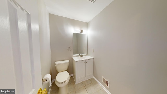 bathroom featuring tile patterned flooring, vanity, and toilet