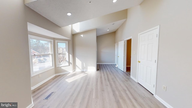 spare room featuring a textured ceiling and light wood-type flooring