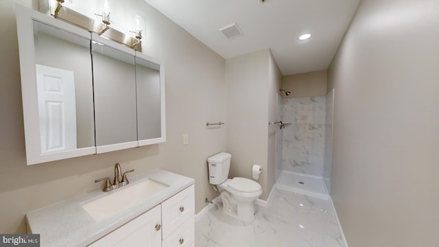 bathroom featuring vanity, toilet, and tiled shower