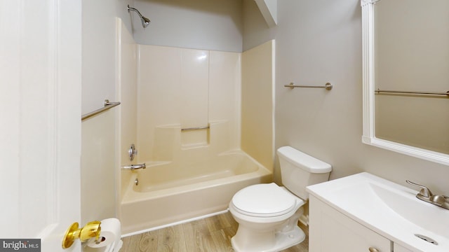 full bathroom with vanity, hardwood / wood-style floors, shower / tub combination, and toilet