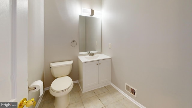 bathroom with tile patterned flooring, vanity, and toilet