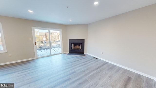 unfurnished living room with light hardwood / wood-style flooring