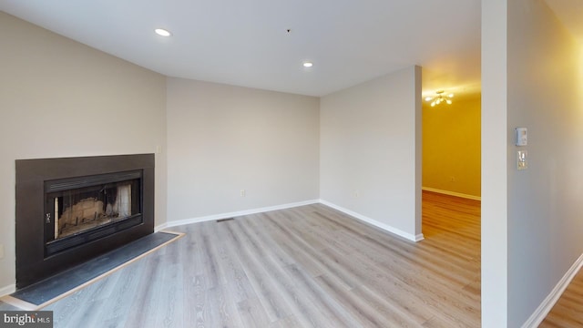 unfurnished living room featuring light hardwood / wood-style floors