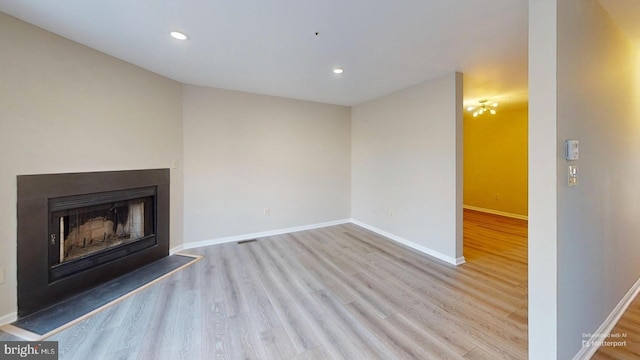 unfurnished living room with light hardwood / wood-style flooring