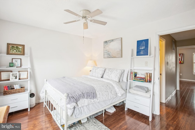 bedroom with dark hardwood / wood-style floors and ceiling fan