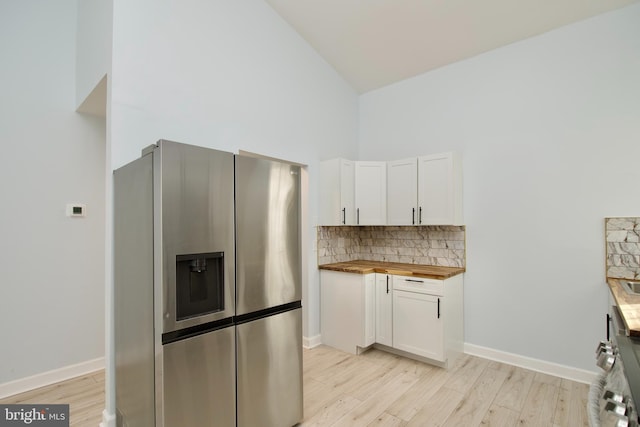 kitchen with white cabinetry, wooden counters, light hardwood / wood-style floors, and stainless steel fridge with ice dispenser