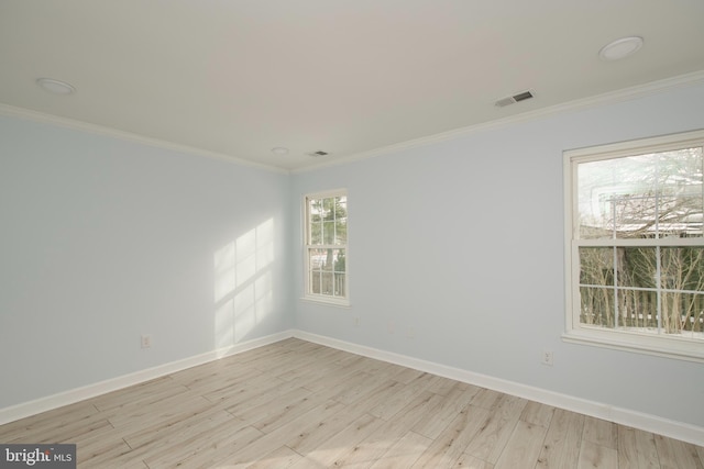 unfurnished room with ornamental molding and light hardwood / wood-style flooring