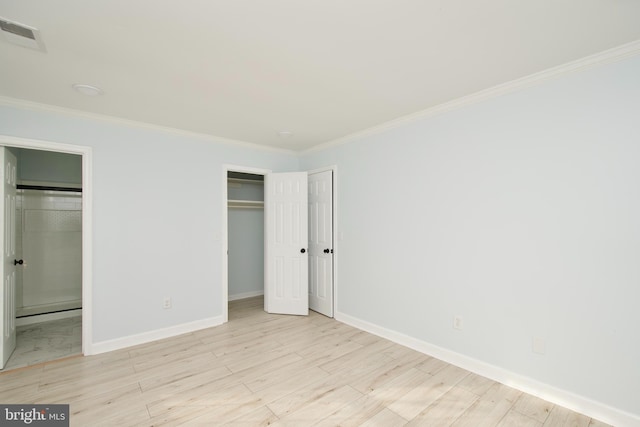 unfurnished bedroom with ornamental molding and light hardwood / wood-style flooring