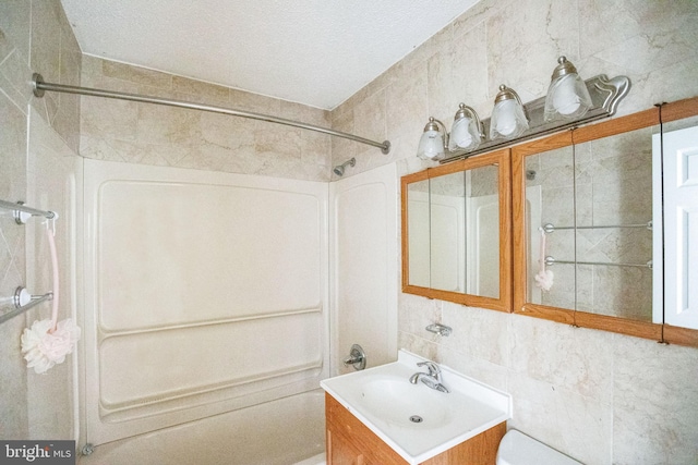 bathroom featuring tasteful backsplash, vanity, tile walls, and  shower combination