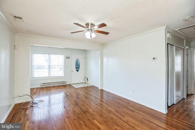 interior space with ornamental molding, dark hardwood / wood-style floors, a textured ceiling, and a baseboard heating unit