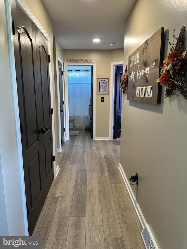 hallway featuring light hardwood / wood-style flooring