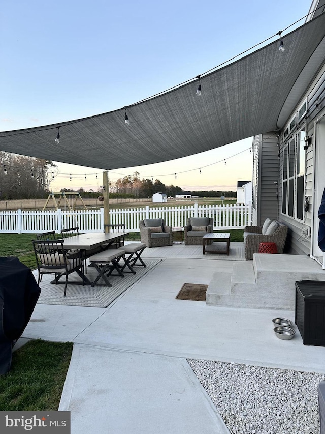 patio terrace at dusk with a water view and grilling area