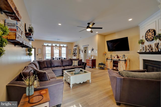 living room with ceiling fan and light wood-type flooring