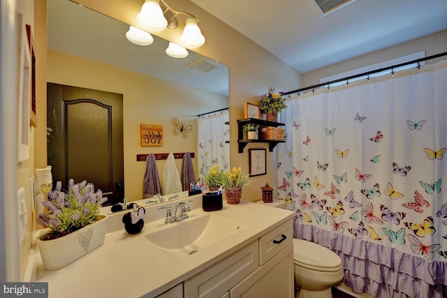 bathroom featuring vanity and toilet