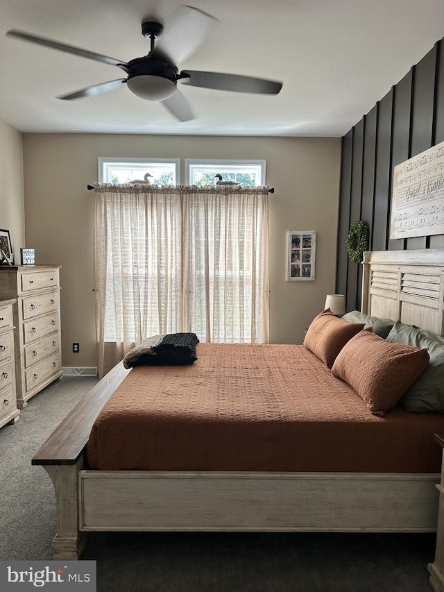 bedroom featuring multiple windows, ceiling fan, and carpet