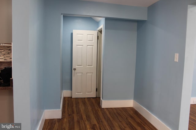 hallway featuring dark wood-type flooring