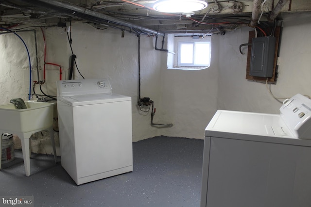 laundry room with washer and dryer, sink, and electric panel