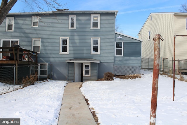 view of snow covered rear of property