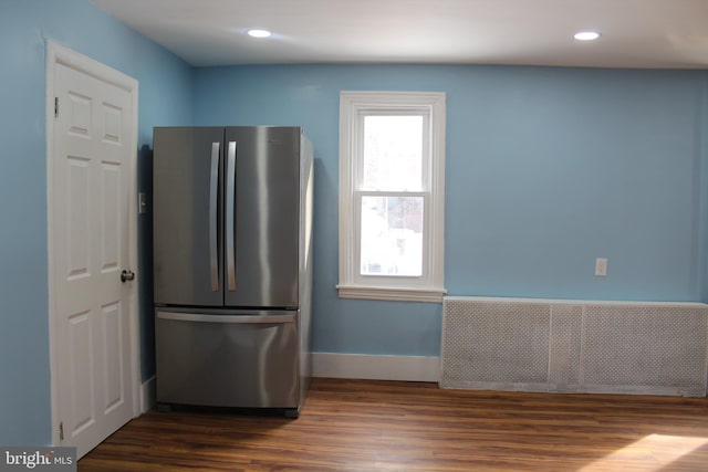 kitchen featuring stainless steel refrigerator, radiator heating unit, and dark hardwood / wood-style flooring