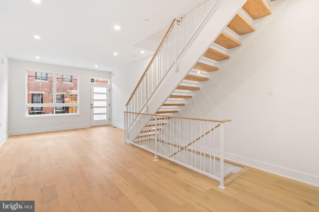 stairs with wood-type flooring