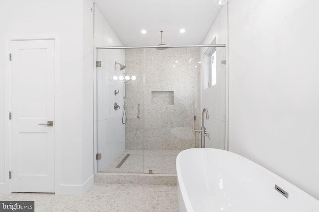 bathroom featuring separate shower and tub