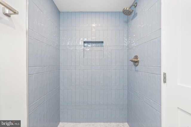 bathroom with a tile shower