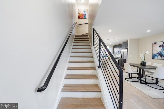 stairs featuring hardwood / wood-style flooring