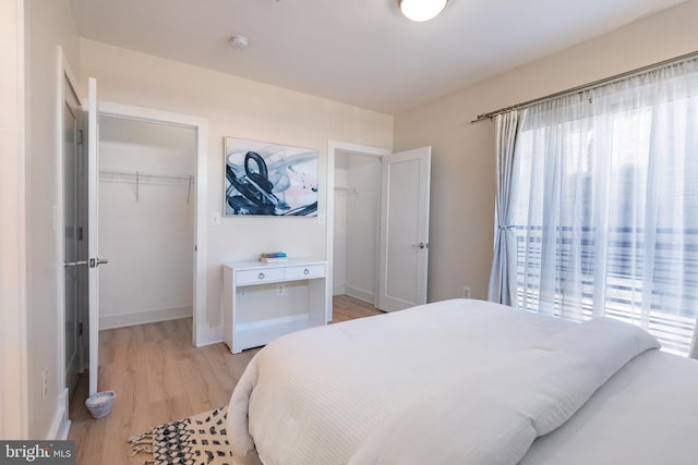 bedroom with light wood-type flooring and a closet