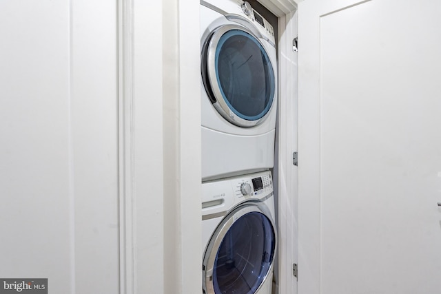 clothes washing area featuring stacked washer / drying machine