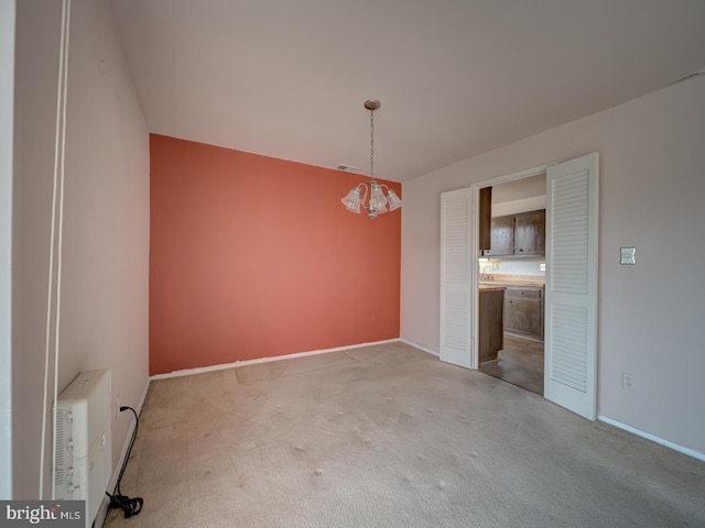 unfurnished room featuring a wall mounted air conditioner and light carpet