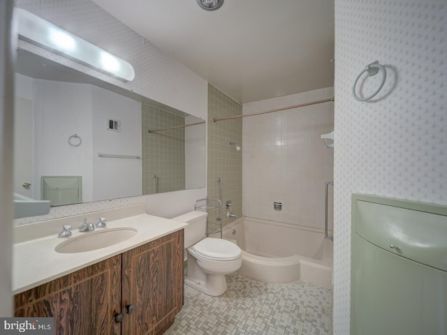 full bathroom with vanity, tiled shower / bath, tile patterned flooring, and toilet