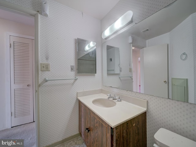 bathroom with vanity and toilet