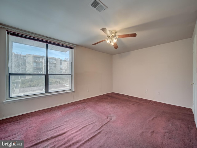 empty room featuring ceiling fan and carpet floors