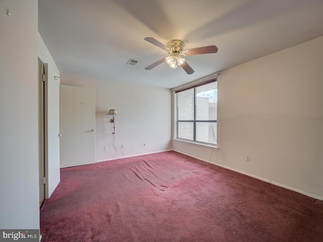 empty room featuring carpet flooring and ceiling fan