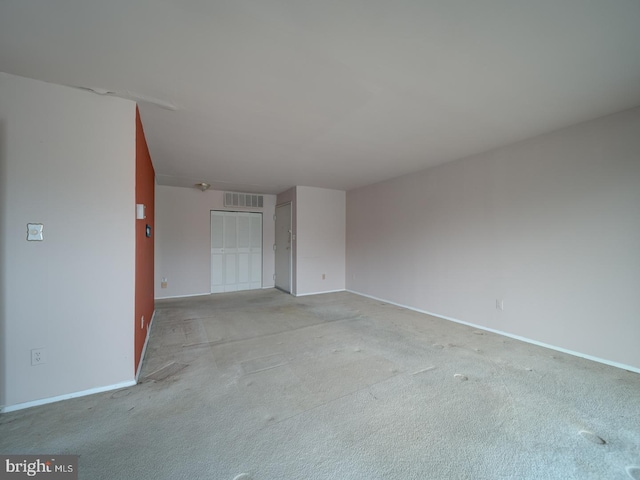 unfurnished room featuring light carpet