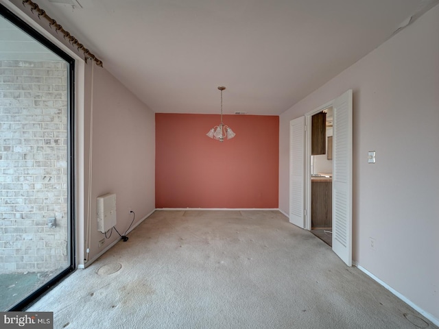 unfurnished dining area featuring heating unit and light colored carpet