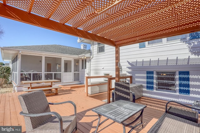 wooden deck with a pergola and a sunroom