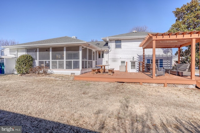 rear view of property with a sunroom, a lawn, a deck, and a pergola