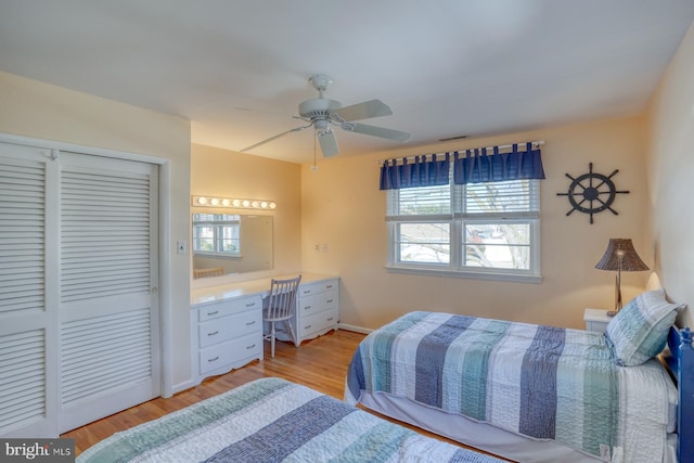 bedroom with a closet, ceiling fan, and light hardwood / wood-style flooring