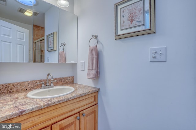 bathroom with vanity and an enclosed shower