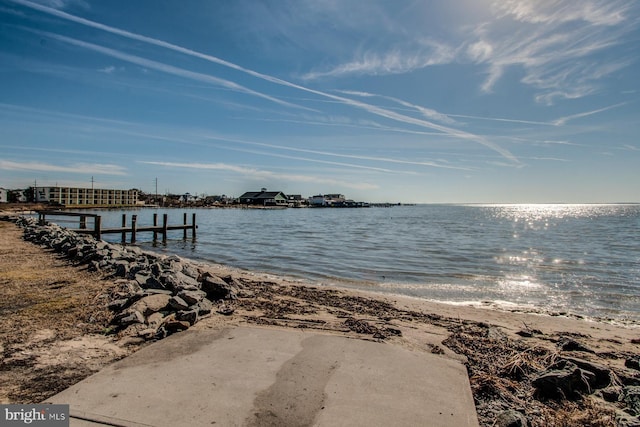 view of dock featuring a view of the beach and a water view