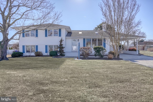 split level home with a carport and a front yard