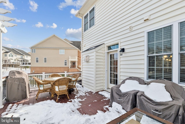 snow covered deck featuring area for grilling