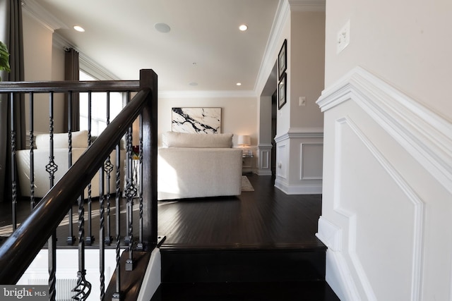 stairway featuring crown molding and hardwood / wood-style floors